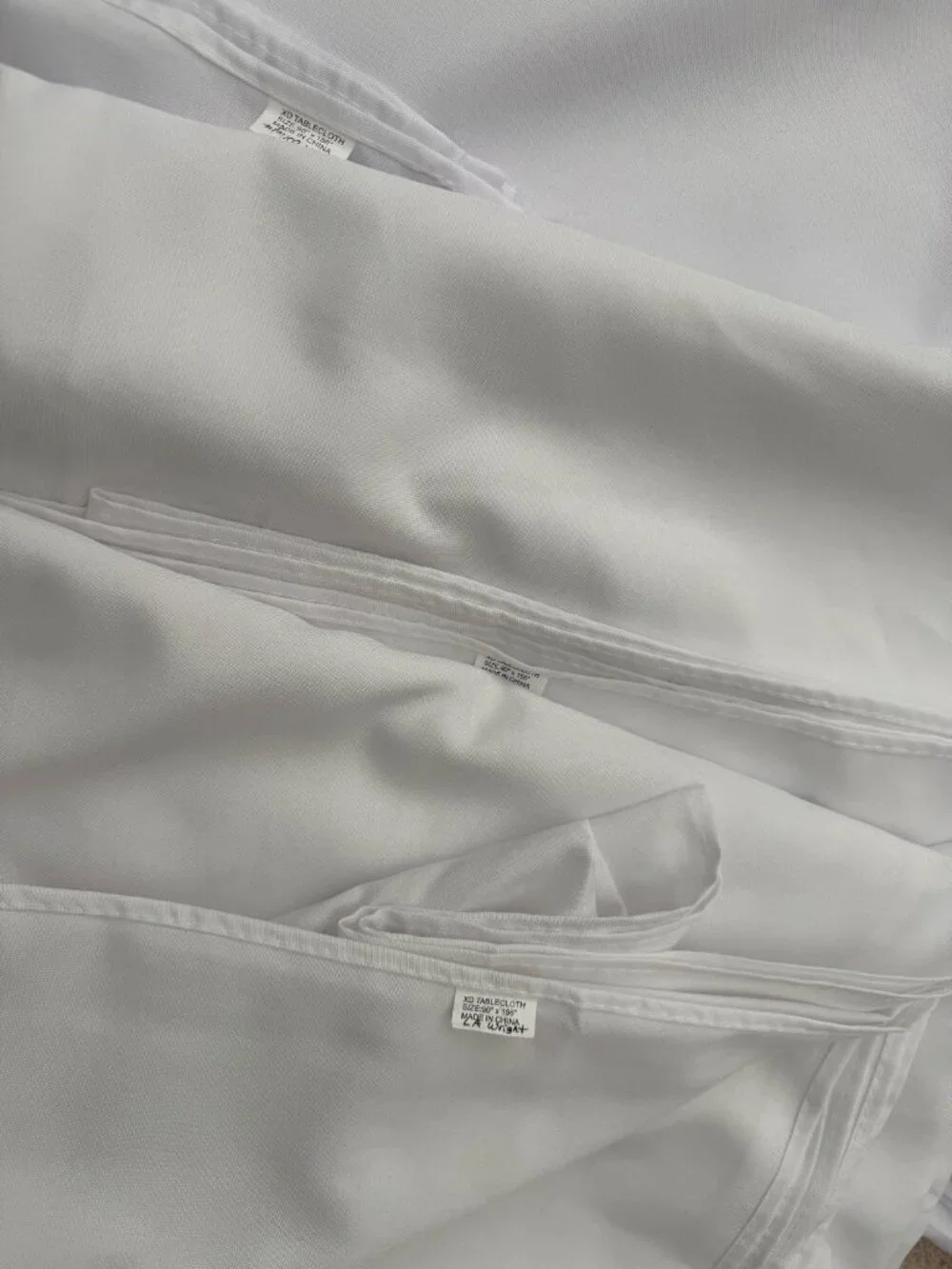 Three solid white rectangular tablecloths for 8 foot tables